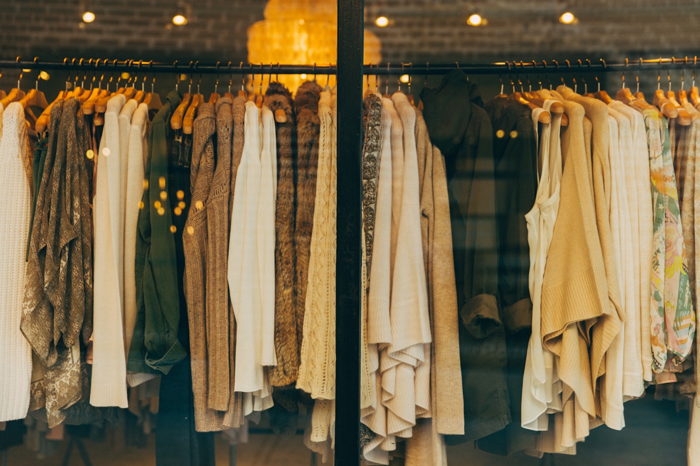 A professional selecting an outfit from an organized weekday wardrobe