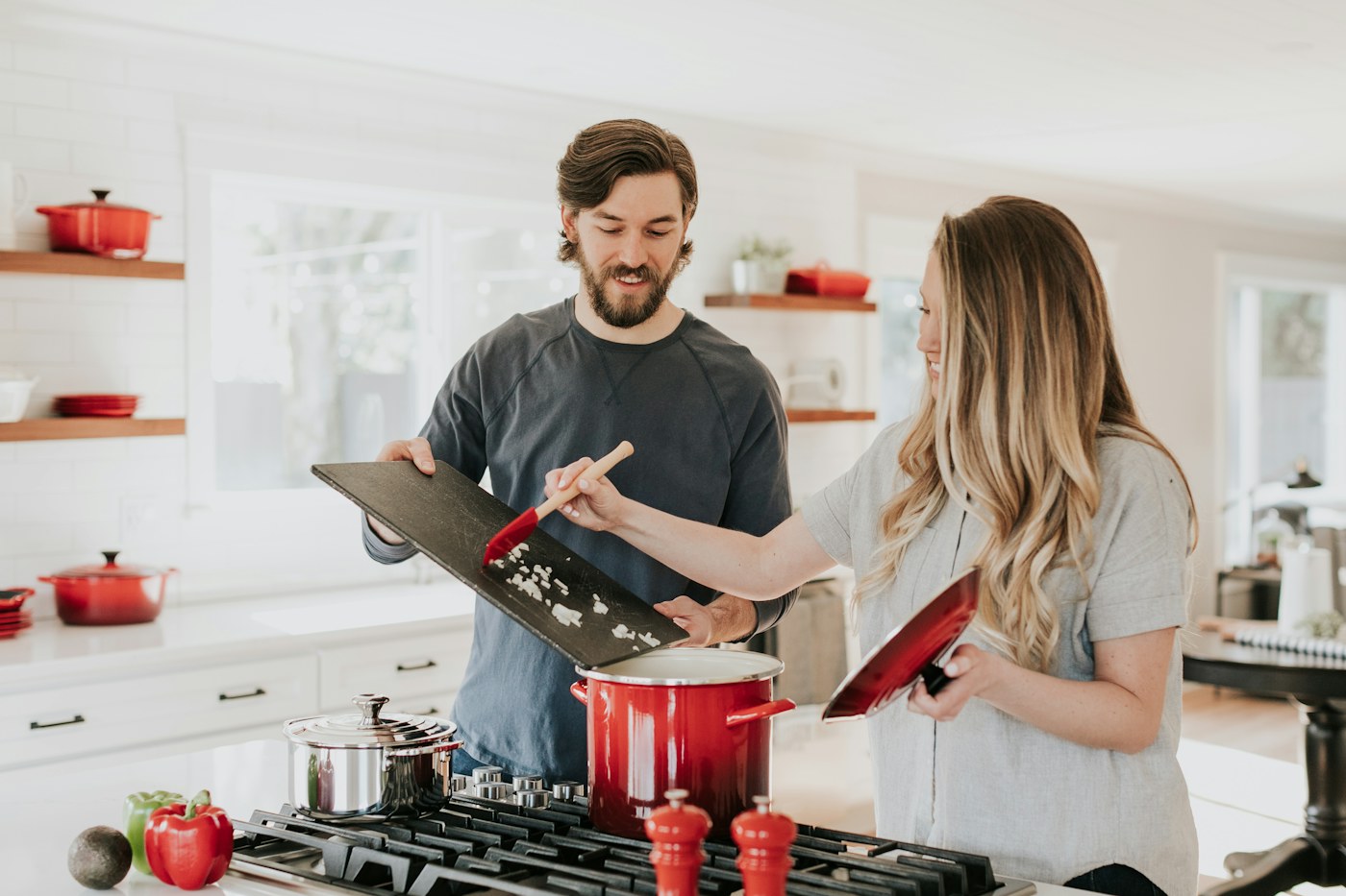 A home cook arranging a small collection of frequently used pots and pans